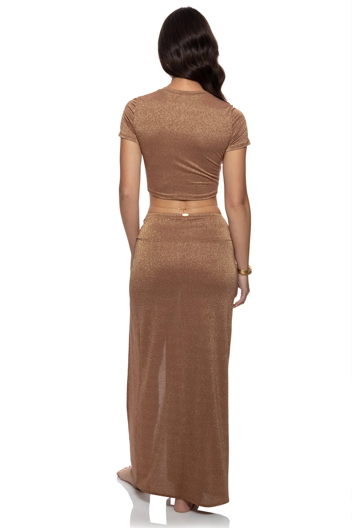 Woman wearing a brown two-piece outfit on a white background