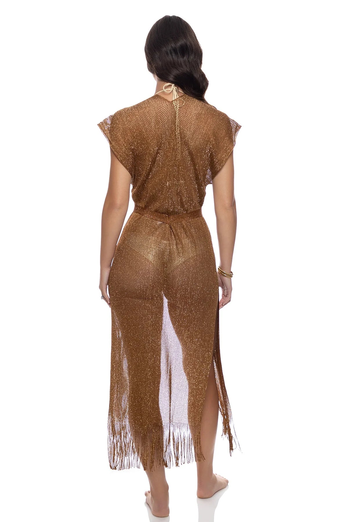 Woman wearing a gold fringe dress on a white background